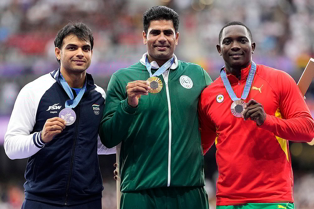 | Photo: AP/Bernat Armangue : Men's javelin gold medalist, Arshad Nadeem, centre, of Pakistan, stands with silver medalist, Neeraj Chopra, of India, and bronze medalist, Anderson Peters, right, of Grenada